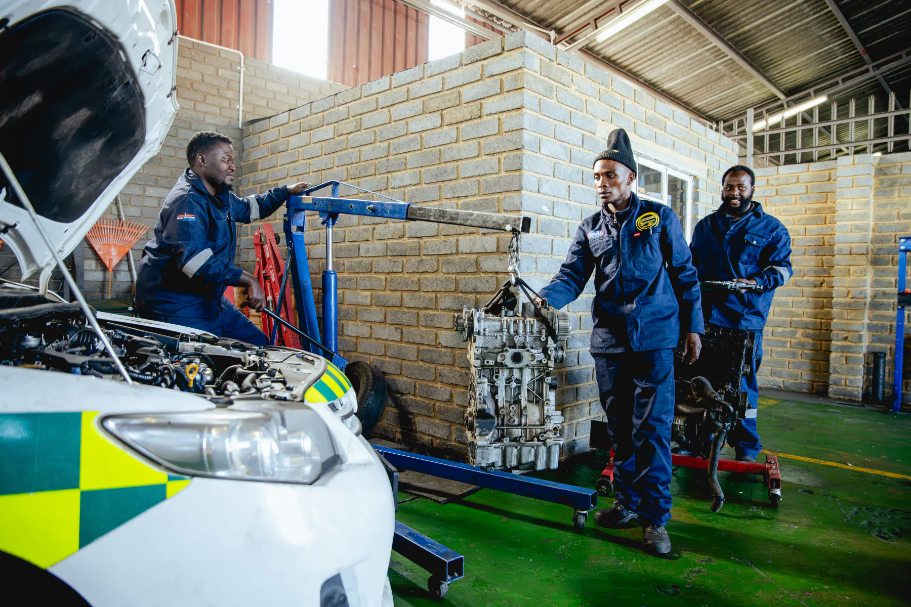 Womech technicians completing an engine repair