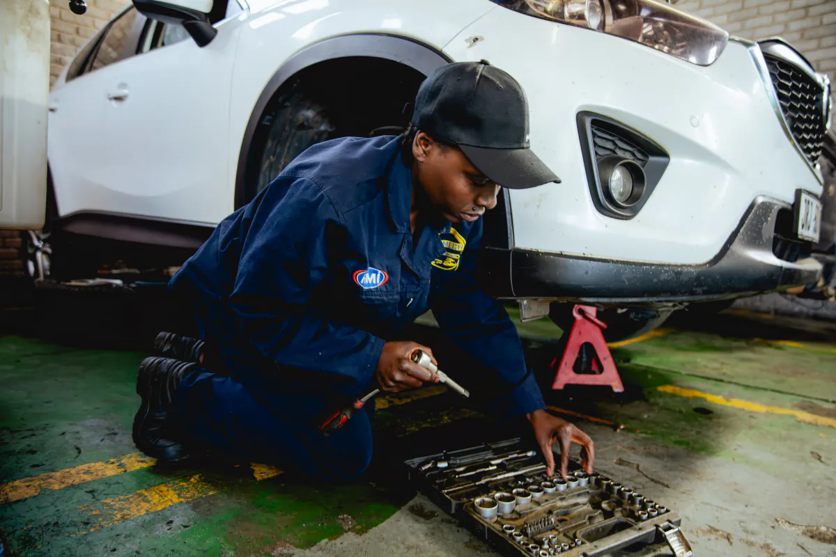 Womech technician working beside a vehicle